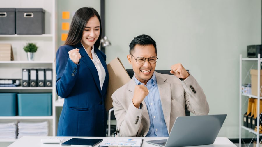 Business owners celebrating compliance with Grof corporate secretarial services Singapore