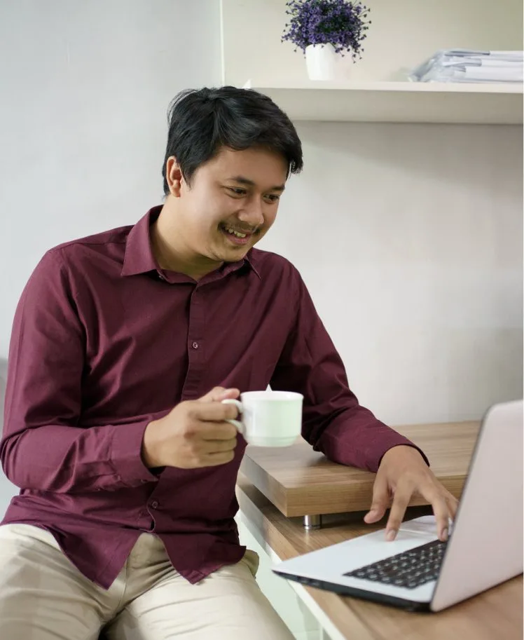 Singapore business owner reviewing outsourced payroll on a laptop